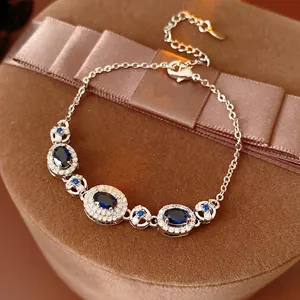 Vintage oval bracelet with deep blue sapphire crystals and diamonds on brown velvet