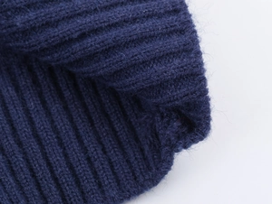 Detail shot of navy blue ribbed knit fabric showing soft texture and wool material
