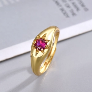 Vintage gold plated ring with starburst set red gemstone in a retro minimalist style