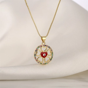 Detailed macro of golden necklace with evil eye heart pendant on silk background