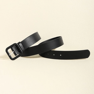 Detail of minimalist black leather belt with a matching leather-wrapped square buckle