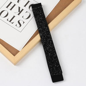 Macro shot of elastic waist belt featuring dense black rhinestones and sparkly crystals