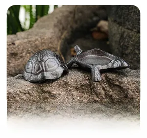 Macro detail of vintage cast iron turtle storage box with removable lid for keys