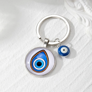 Evil eye glass keychain featuring double blue and orange pendants with polished silver ring