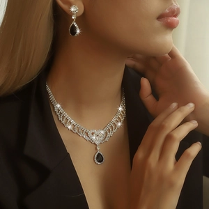 Close-up of bridal jewelry set with black teardrop crystals and silver rhinestones