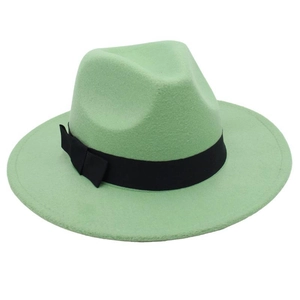 Close-up of mint green vintage fedora hat with black ribbon and felt texture details