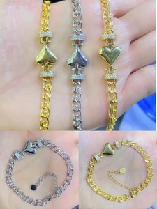 Detailed macro view of 18K gold plated heart bracelet with micro-pave cubic zirconia accents