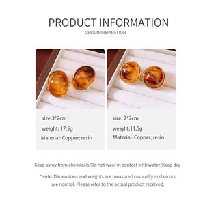 Detail view of amber resin earrings with size and weight specs on informational card