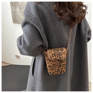 Close-up of leopard print crossbody phone bag with vintage toggle button and suede texture