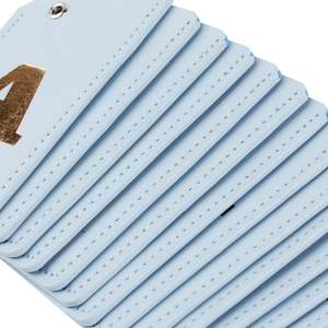 Stack of light blue PU leather luggage tags with golden number four on a white background