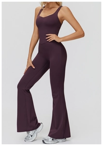 Detail of cross-back straps and flared leg design on a dark purple yoga jumpsuit