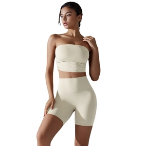 Women's cream two-piece athletic set featuring a strapless tube top and high-waisted shorts