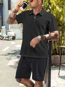 Detailed view of the waffle texture fabric on this black men's casual polo shirt and shorts set
