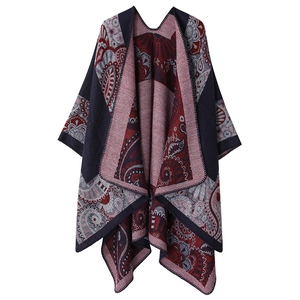 Close-up of paisley pattern on warm knitted shawl in dark red, navy and grey