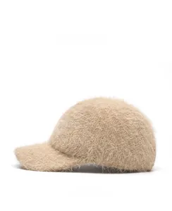Side view of beige fuzzy knit baseball cap with thick plush fur texture for winter