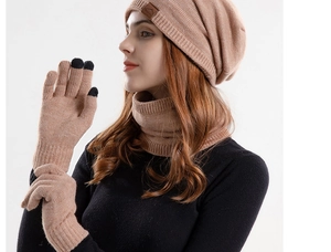 Close-up of winter knit beanie set with touch screen gloves and fleece lining in camel