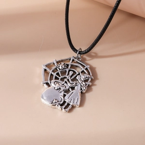 Detail of vintage silver witch cauldron pendant with spider web on black cord necklace