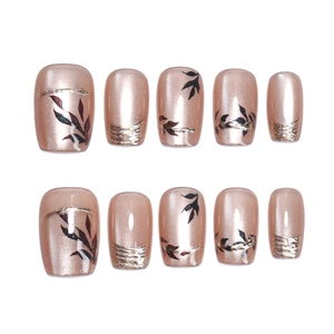 Nude pink cat-eye press on nails with gold foil leaf patterns and pearl finish