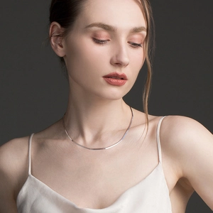 Classic 1.8mm S925 sterling silver flat snake chain necklace worn by a female model