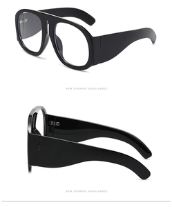 Detail view of large black flat top fashion sunglasses with thick temples on white background