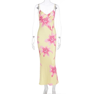 Close-up of a floral V-neck bodycon maxi dress with pink lily print on light yellow fabric
