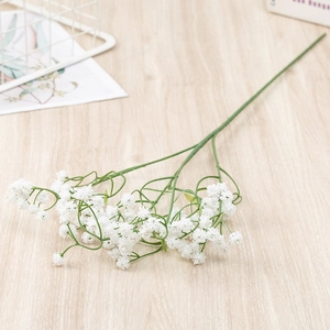 Single white artificial gypsophila bundle on wooden surface for home and wedding decor