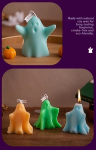Colorful ghost-shaped soy wax candles for Halloween decor on a cozy wooden surface