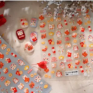 Detail of 3D embossed New Year nail stickers with cat and red envelope festive patterns