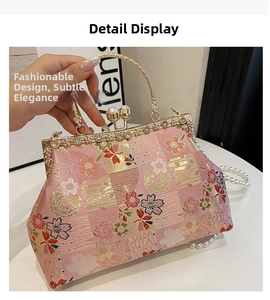 Detailed close-up of pink floral embroidery and pearl clasp on a Chinese style bag