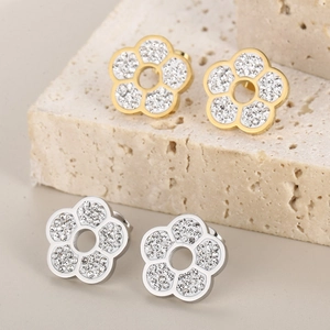 Sparkling crystal flower earrings set in gold and silver finish on stone display