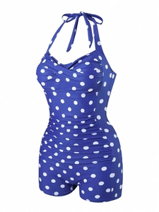 Detail of ruched waist and retro polka dot print on royal blue one piece swimsuit