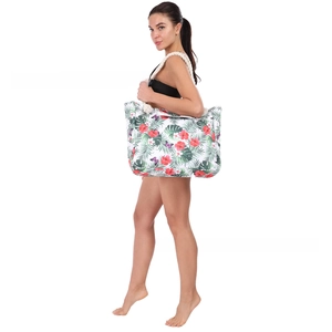 Detail view of large tote bag featuring tropical floral patterns and thick rope handles