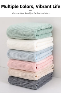 Detail of waffle-textured coral fleece towel set in six assorted pastel and neutral colors