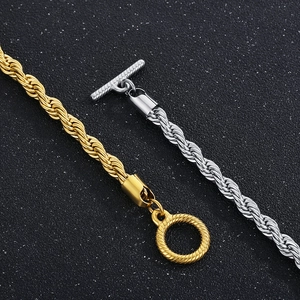 Detail of twisted curb chain necklaces in gold and silver with stylish OT buckle design