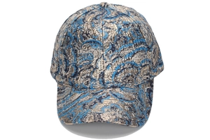 Close-up of blue and gold jacquard baseball cap with textured wavy metallic pattern
