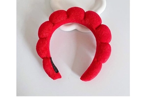 Detail of red velvet padded headband with unique sphere texture and plush finish