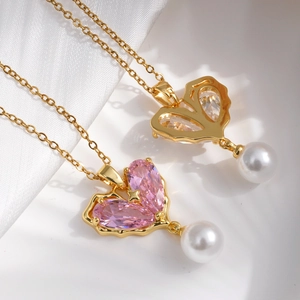Golden butterfly necklace with pink and clear stones and pearls on white silk