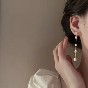 Detail of elegant French pearl tassel earrings with cascading white freshwater pearls