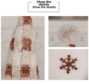 Detail showing checkered knit fabric, plush faux fur, and brown felt snowflake patches
