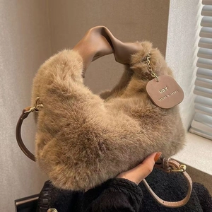 Detail of soft brown faux fur texture and stylish knotted khaki leather handle