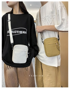 Detailed shot of casual canvas crossbody bags in white and mustard yellow on models