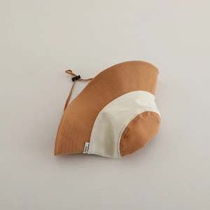 Close-up of kids color-block sun hat with adjustable drawstring and KUKU label
