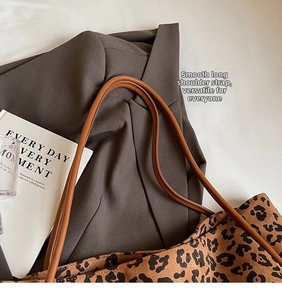 Detail of leopard print fabric tote bag with premium brown leather shoulder straps