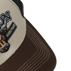 Detail of bull embroidery and breathable mesh on a beige retro trucker baseball cap
