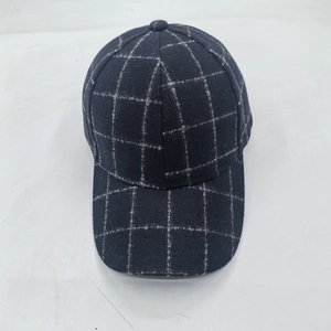 Close-up of navy blue plaid baseball cap with thick wool texture and fine stitching