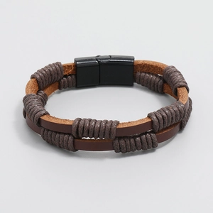 Detail view of multi-layer brown woven leather bracelet with black magnetic metal clasp