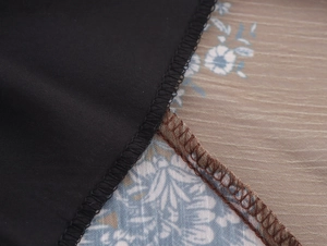 Close-up of overlock stitching and floral chiffon fabric seams for quality detail