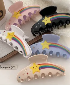 Detailed set of 5 colorful star hair claws with rainbow stripes and small rhinestones