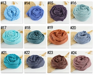 Detailed grid view showcasing twelve different solid colors of soft cotton linen scarves