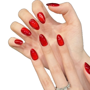 Sparkling wine red almond press-on nails with cat-eye glitter and silver ring